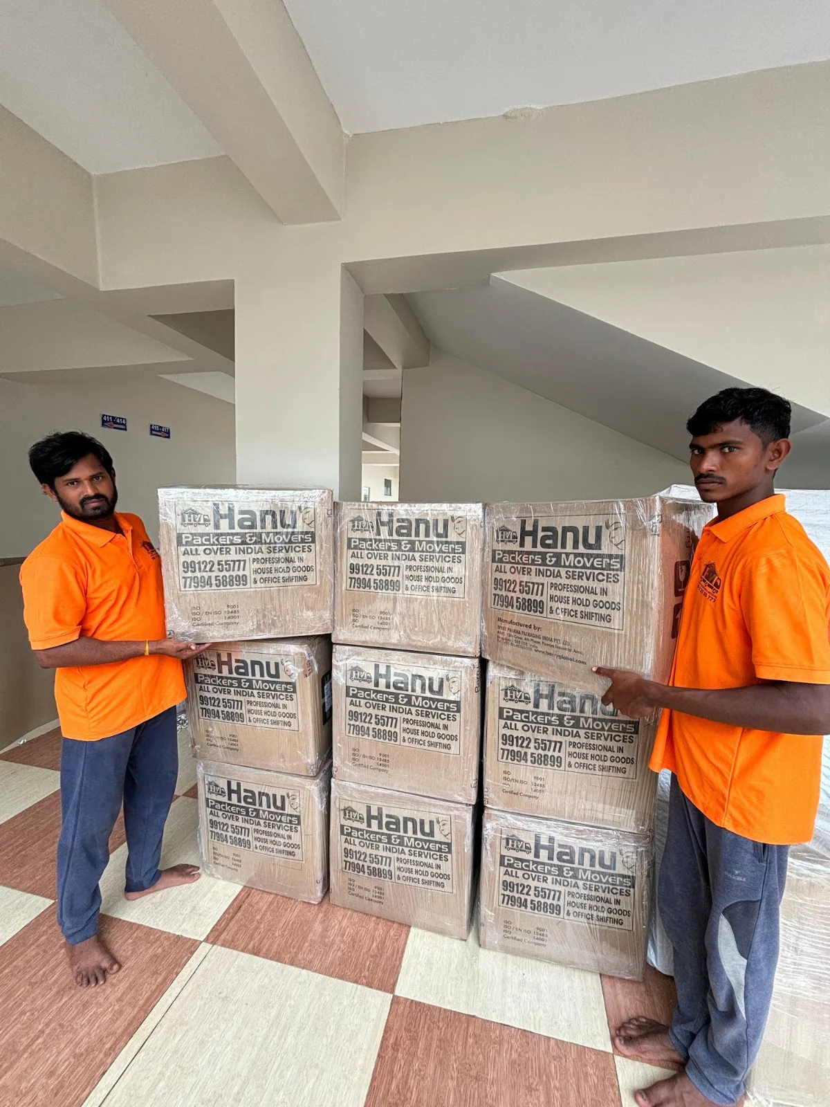 Hanu Packers and Movers team with packed cartons in Kakinada
