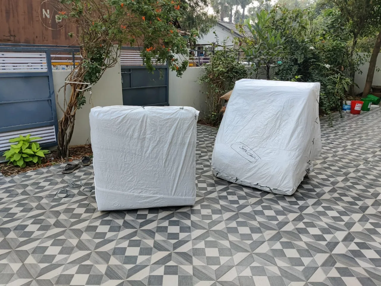 Sofa chairs wrapped in protective sheet for shifting in Rajahmundry
